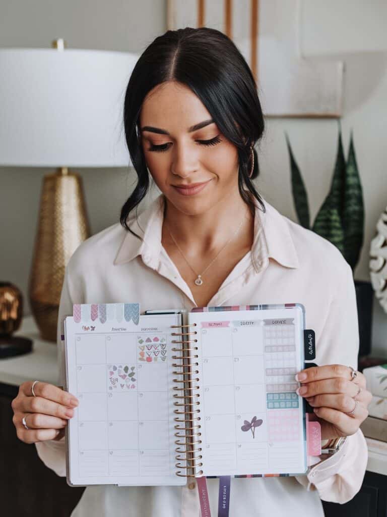 a woman showing her sticker planner layout
