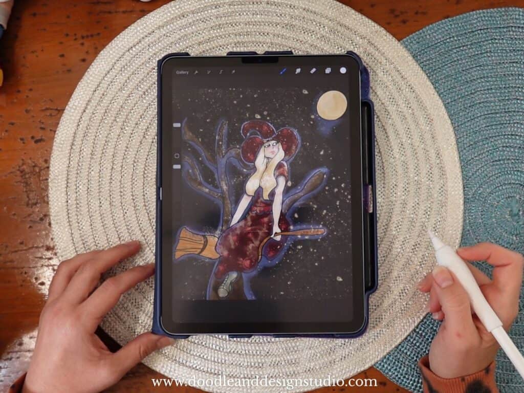 dark colored witch drawing on Procreate sitting on a wooden desk