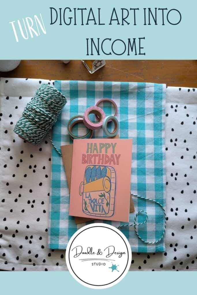 A handmade illustrated greeting card on a gingham fabric background with craft supplies and text reading “Turn Digital Art Into Income.”