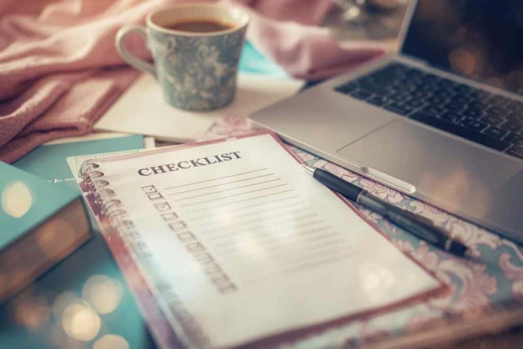 A checklist for preparing a first digital product listing, shown on a cozy artist’s desk.