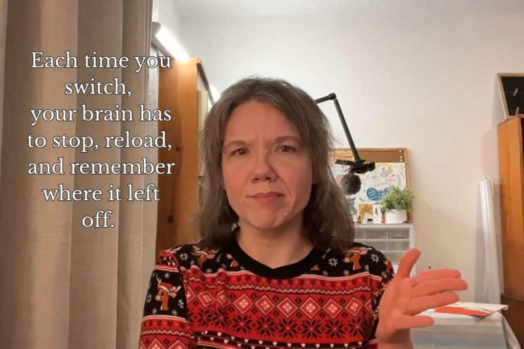 A woman gestures with one hand while explaining mental load; text reads “Each time you switch, your brain has to stop, reload, and remember where it left off.”